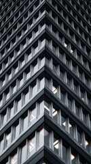 Obraz premium Dramatic low-angle view of modern skyscraper corner with glowing windows.