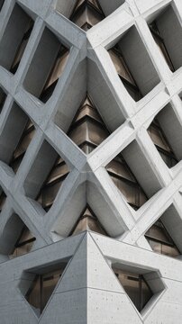 Intricate geometric concrete facade of a contemporary building.
