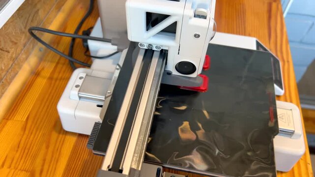 3d printer creating red plastic object layer by layer