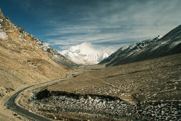 Aerial and ground views of Mount Everest from the Tibetan side. Majestic snow-covered peaks of the Himalayas rising above the high-altitude plateau under clear blue skies