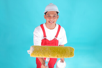 Cheerful Painter Asian Man Doing Renovation Painting Against Blue Background Studio