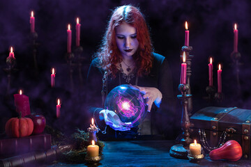 Witch casts a spell with magic Crystal ball for predictions fortune-telling. Young woman, magician...