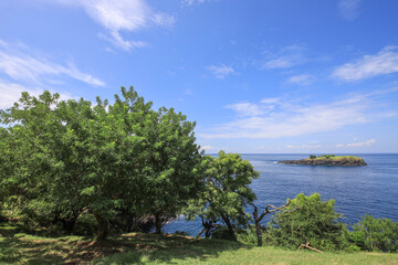 Beautiful blue ocean with a small island in the distance