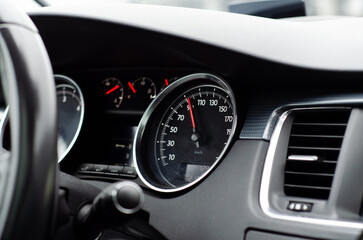 Car dashboard close-up showing speed at 80 kmh during morning commute