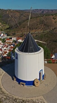  Aerial view of small village with windmill and picturesque rooftops, Odeceixe, Portugal