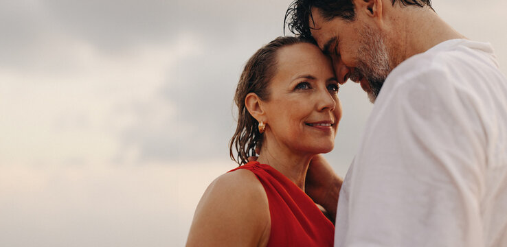 Lasting love between older couple enjoying luxury holiday at the beach - Powered by Adobe