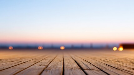 A wooden deck stretches toward a softly lit cityscape at dawn or dusk,