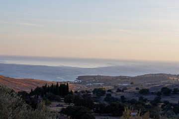 Scenic coastal landscape with rolling hills and distant sea view.