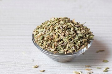 Closeup of Fennel Seed Heap in a Glass Bowl Isolated on White Background with Copy Space