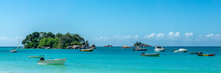 Boats at Anse Lazio panorama, scenic beach in Praslin island, Seychelles web banner
