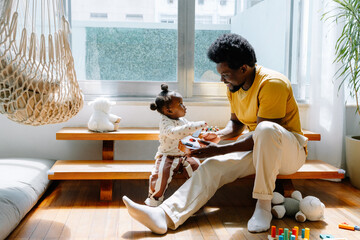 Father and child share a playful moment indoors