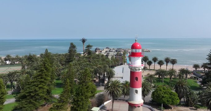Aerial drone shot, flying over the streets of Swakopmund and the historic Swakopmund Lighthouse in Namibia.	
