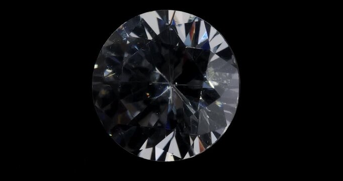 Jewelry zirconia stone on a dark background. Artificial gemstone on a rotating table.