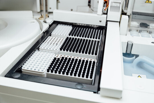 Advanced automated machine processing rows of test tubes and vials, performing diagnostic analyses in a modern medical laboratory, ensuring precision in healthcare research