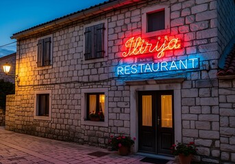 Ilirija Restaurant - A charming stone building with vibrant neon signage.