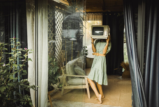 woman holding retro tv set