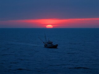 Fishing boats at sea at sunset 