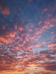 Fototapeta premium A vibrant sunset paints the sky with colorful orange and pink hues casting a warm glow over distant coastal clouds and a serene horizon