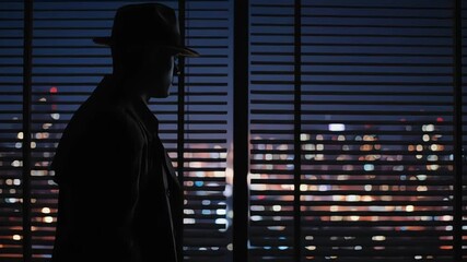 A mysterious figure in a fedora observes the illuminated city lights through window blinds. - Powered by Adobe