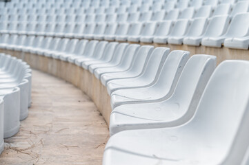 Fototapeta premium Empty seating in a large outdoor arena ready for an upcoming event during daylight hours