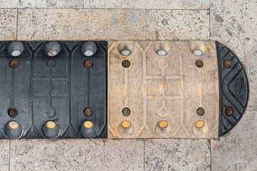 Unique sidewalk design featuring two contrasting colors and textures in a city location