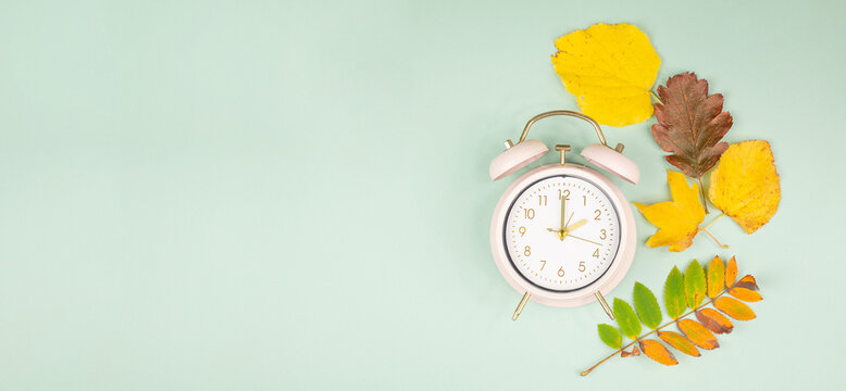 Autumn time change, end of daylight saving time, alarm clock fall back switch, colorful foliage, winter season