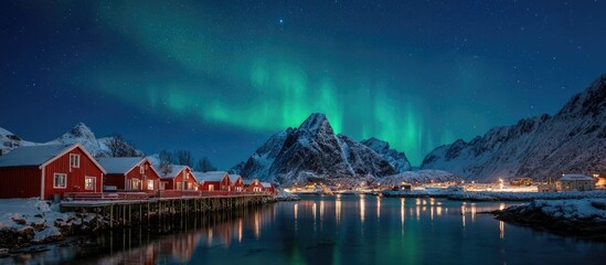 Fototapeta premium Snowy Red Cabins with Northern Lights and Mountain Landscape