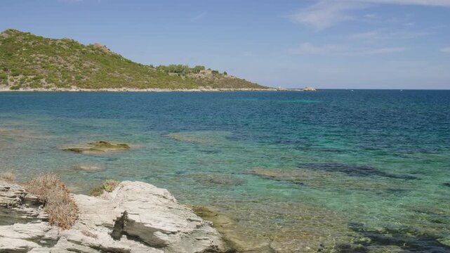 Saint-Florent Corsica coast sunny view of crystal clear turquoise waters northern Corsican seaside rocky shorelines under a bright blue sky serene Mediterranean landscape untouched natural beauty