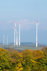 Wind turbine park, autumn colored foliage, windmills, efficiency renewable sustainable energy, electricity technology, environment conversation