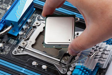 Hand Installing CPU Processor in Motherboard Socket for Computer Upgrade