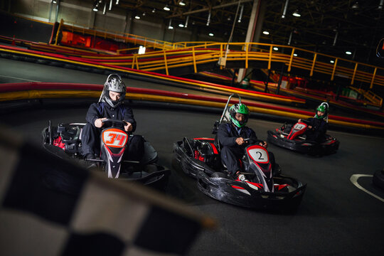 Exciting moments in an indoor karting arena as racers prepare for the next thrilling lap - Powered by Adobe