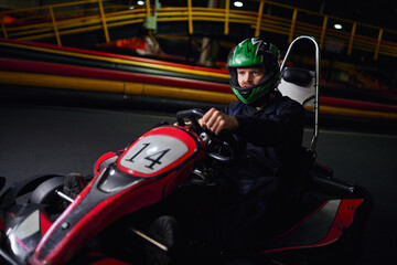 Fototapeta premium Exciting indoor go kart racing experience for leisure and fun at the track