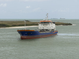 Fototapeta premium Modern dredging vessel deepening navigation channel in seaport. powerful modern dredger working in port, deepening the navigation channel with heavy marine equipment. 