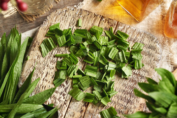 Chopping fresh ribwort plantain leaves to prepare homemade herbal syrup for cough © Madeleine Steinbach