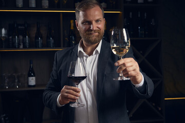 Sommelier comparing red and white wine with confident expression. Concept of education and sensory analysis, luxury beverage promo, showing expertise, balance, and mindful focus.