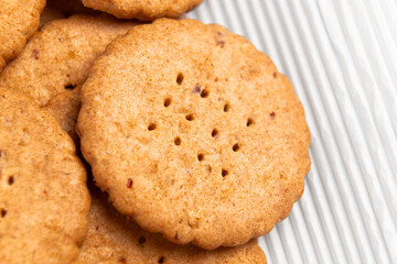 Round holey shortbread cookies on white paper