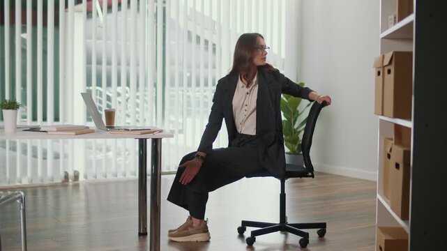 Sustainable Office and Employee Wellness. Office Manager Practices Seated Spinal Twist for Thoracic and Lumbar Spine to Improve Flexibility, Reduce Tension, Support Posture and Encourage Healthy Eco
