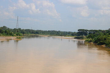 Discover a serene river landscape with lush greenery and clear skies, perfect for travel blogs, nature documentaries, and calming desktop wallpapers today