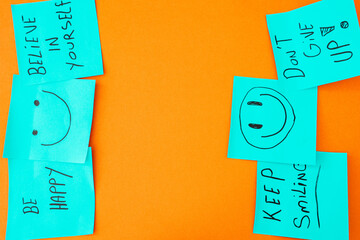 Sticky notes with a positive message, on a orange background.