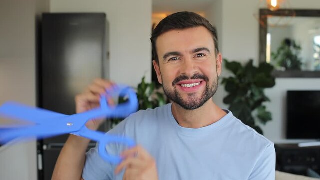 Man holding a pair of gigantic blue scissors 
