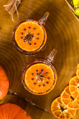 Autumn composition with pumpkin, quince and cup of tea with star anise on wooden table