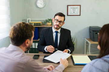 Attorney explaining divorce agreement to married couple