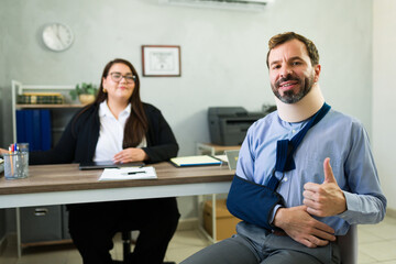 Injured man completing insurance claim with agent