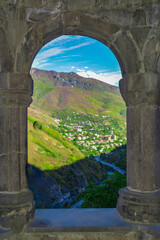 Beautiful arches and a city in nature. Beautiful cityscape and windows. Beautiful architecture with arches. A window to paradise. Church architecture. Alaverdi, Armenia.