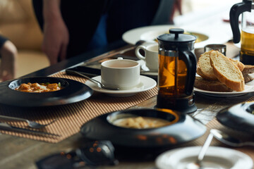 Lunch time. Close-up view of table laid with delicious dishes and french press with tea in restaurant