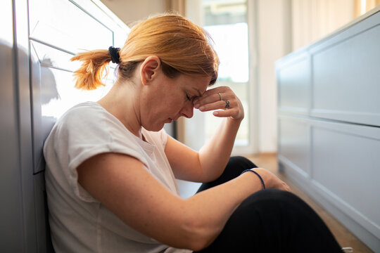 Middle aged woman feeling stressed at home