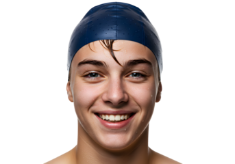 A young male swimmer with a blue swim cap smiles broadly at the camera, isolated on a white background.