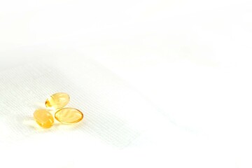 Three Fish Oil Capsules on White Background