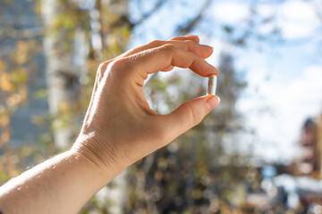 Close-up of Woman's Hand Holding Pill Capsule