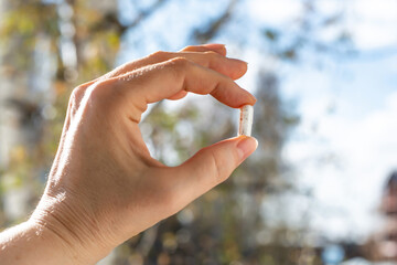 Close-up of Woman's Hand Holding Pill Capsule